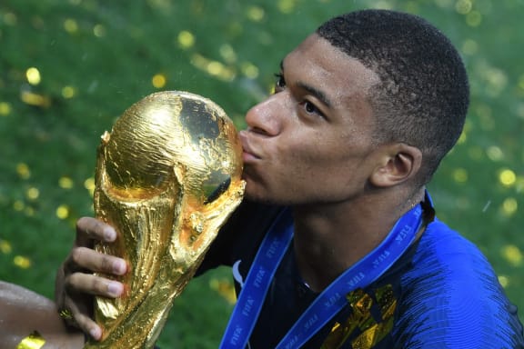 France's forward Kylian Mbappe kisses the trophy after the team's 4-2 win over Croatia in the Russia 2018 World Cup final at the Luzhniki Stadium in Moscow.