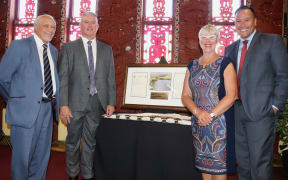 Dr Sir Toby Curtis (left), Minister for Māori Crown Relations Kelvin Davis, Rotorua Mayor Steve Chadwick, and Waiariki MP Tamati Coffey with the Certificate of Title for Lake Ōkaro, which was officially handed to Te Arawa today.