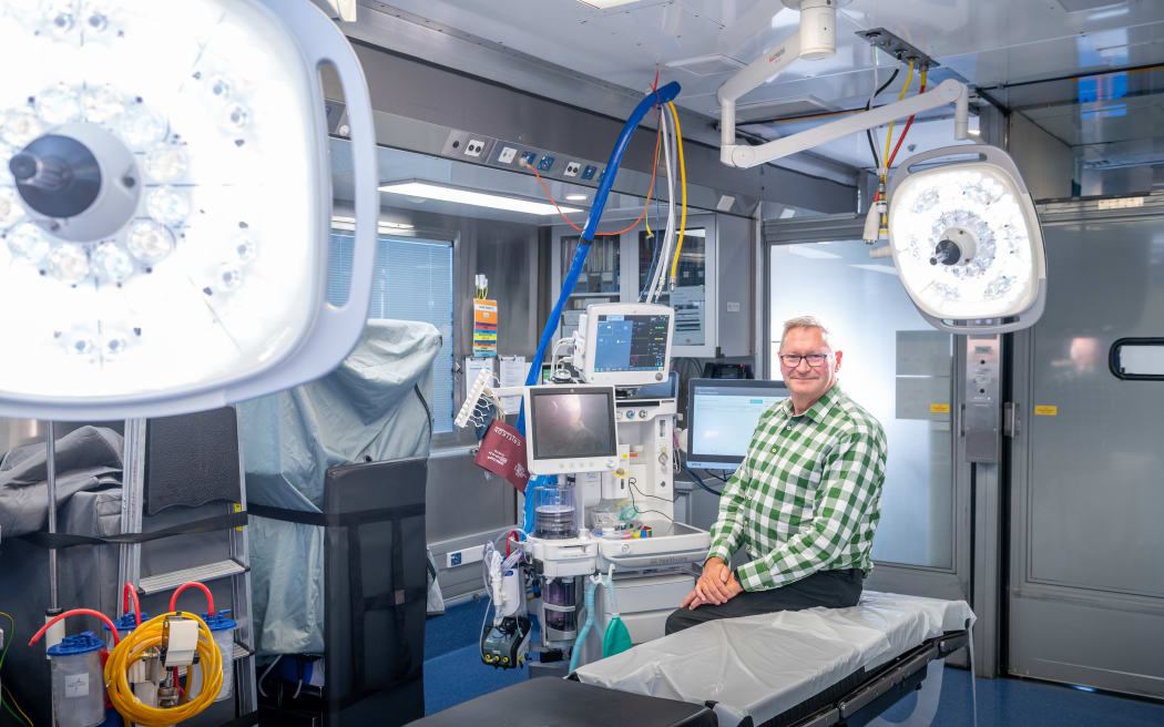 Operating theatre inside truck with man sitting on operating table