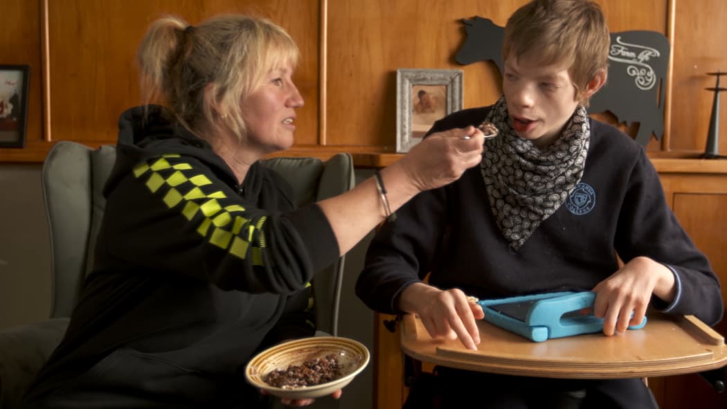 Pip Cook feeds her severely disabled foster son Ryan.