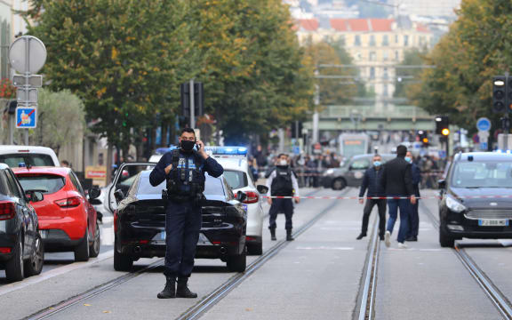 French policemen stand guard a street after a knife attack in Nice.