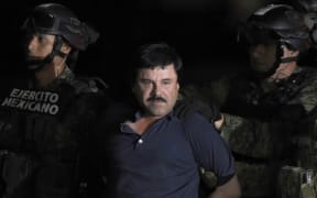In this file photo taken on January 8, 2016 Mexican Drug kingpin Joaquin "El Chapo" Guzman is escorted into a helicopter at Mexico City's airport following his recapture during an intense military operation in Los Mochis, in Sinaloa State.