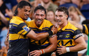Billy Proctor celebrates scoring a try with team mates.