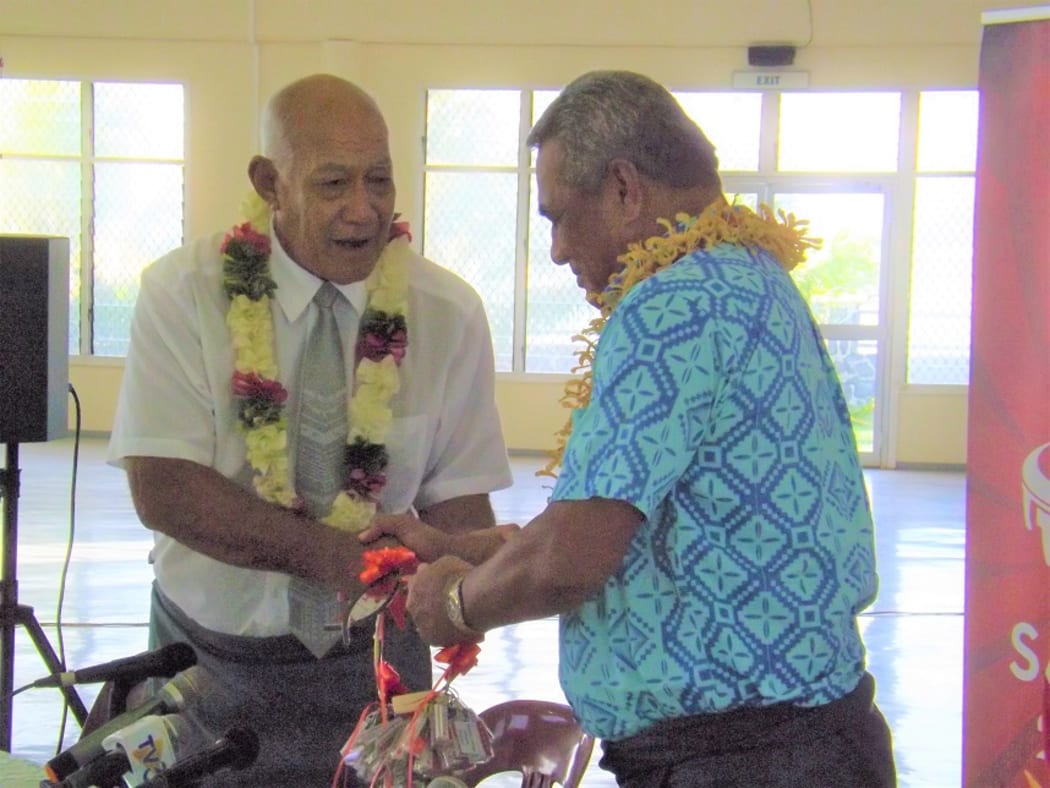 The Reverend Apineru Lafai (left) hands keys over to the Minister of Sports Loau Keneti Sio