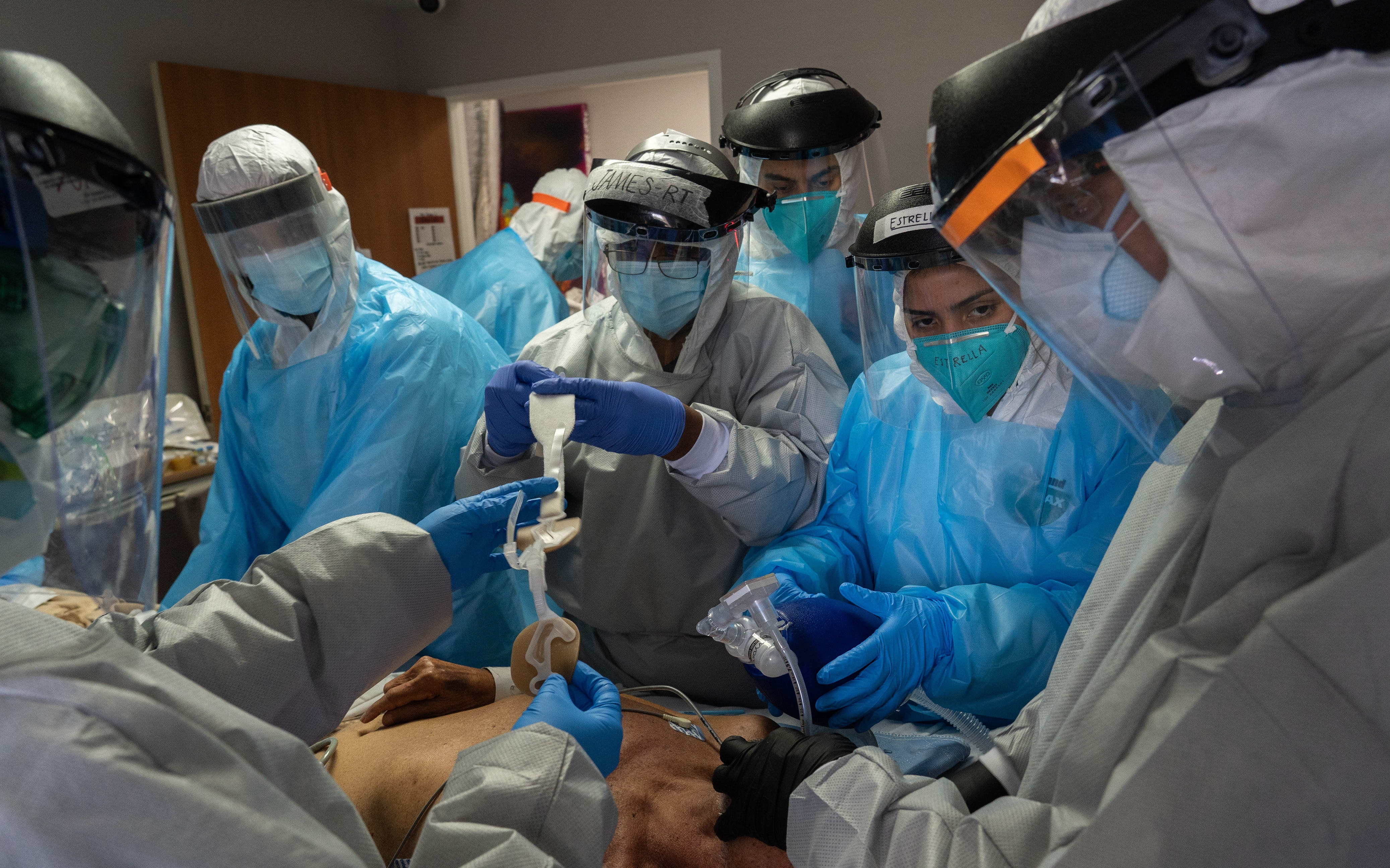 Medical workers wearing personal protective equipment (PPE) treat a patient suffering from the coronavirus disease in the Intensive Care Unit (ICU) of the United Memorial Medical Center in Houston, Texas, the United States.