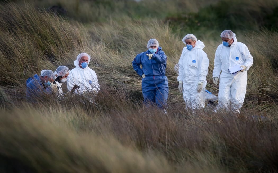 Police forensics standing around the alleged body of Alex Fisher.