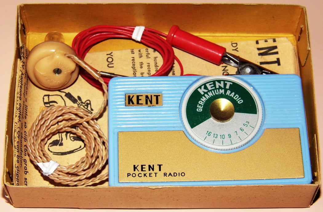 1950s-era crystal radio set. The antenna wire has a clip to attach to a metal object and improve reception.