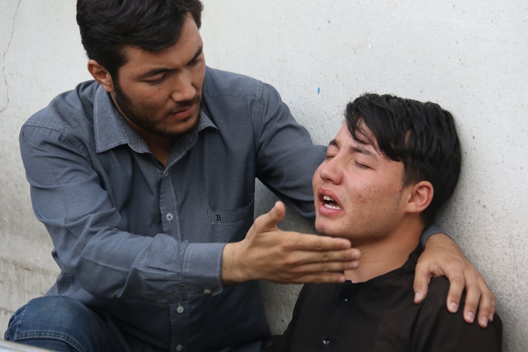 An Afghan resident cries for his relative following a suicide attack in Kabul.