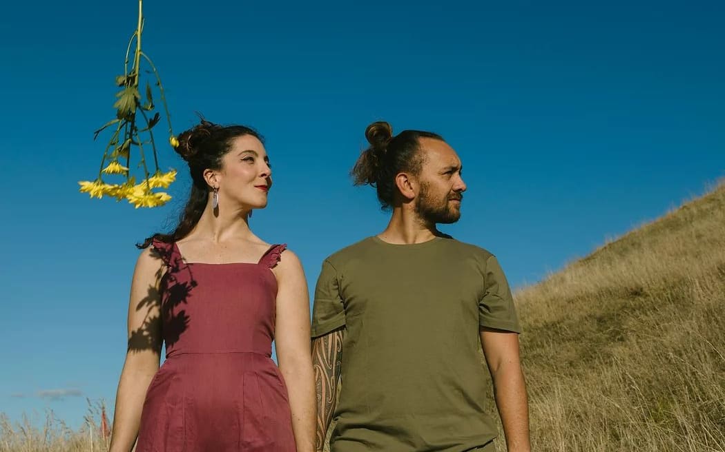 A photograph of husband and wife Charles (Ngāpuhi, Te Rarawa, Ngāti Te Ata, Te Ati Awa) and Emily Looker who make music under the name Aro.