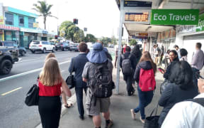 Commuters wait at Mt Roskill shops for a replacement bus supposed to arrive every 15 minutes - many people had been waiting longer.