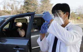 SANTA ROSA, CALIFORNIA - JANUARY 13: Safeway pharmacist Preston Young fills a syringe with Moderna COVID-19 vaccination during a drive-thru COVID-19 vaccination clinic at the Sonoma County Fairgrounds on January 13, 2021 in Santa Rosa, California.