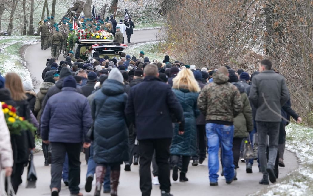 Mourners attend the funeral of one of two victims of a missile that hit a southeastern Polish village near the border with Ukraine, in Przewodow on November 19, 2022. - The explosion of the missile occurred on November 15, 2022 as Russia targeted Ukraine with a massive attack on civilian infrastructure which left millions of households without power. Russian missiles hit cities across Ukraine, including Lviv near the Polish border. (Photo by JANEK SKARZYNSKI / AFP)