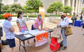 New Yorkers in need receive free produce, dry goods, and meat at a Food Bank For New York City distribution event at Lincoln Center on 29 July, 2020, in New York City