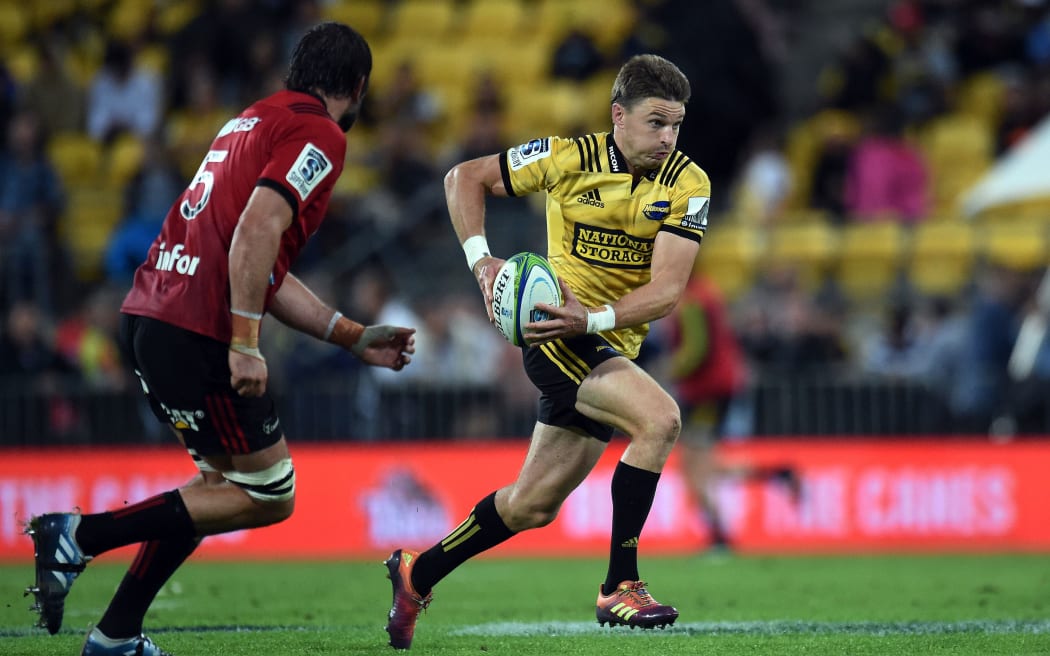 Hurricanes first five Beauden Barrett comes under pressure from Crusaders captain Sam Whitelock.