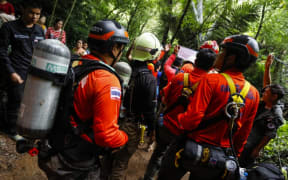 Thai rescue personnel arrive at the Tham Luang cave to conduct operations to find the missing members of the children's football team in a cave chamber along with their coach at the cave in Khun Nam Nang Non Forest Park in Chiang Rai.