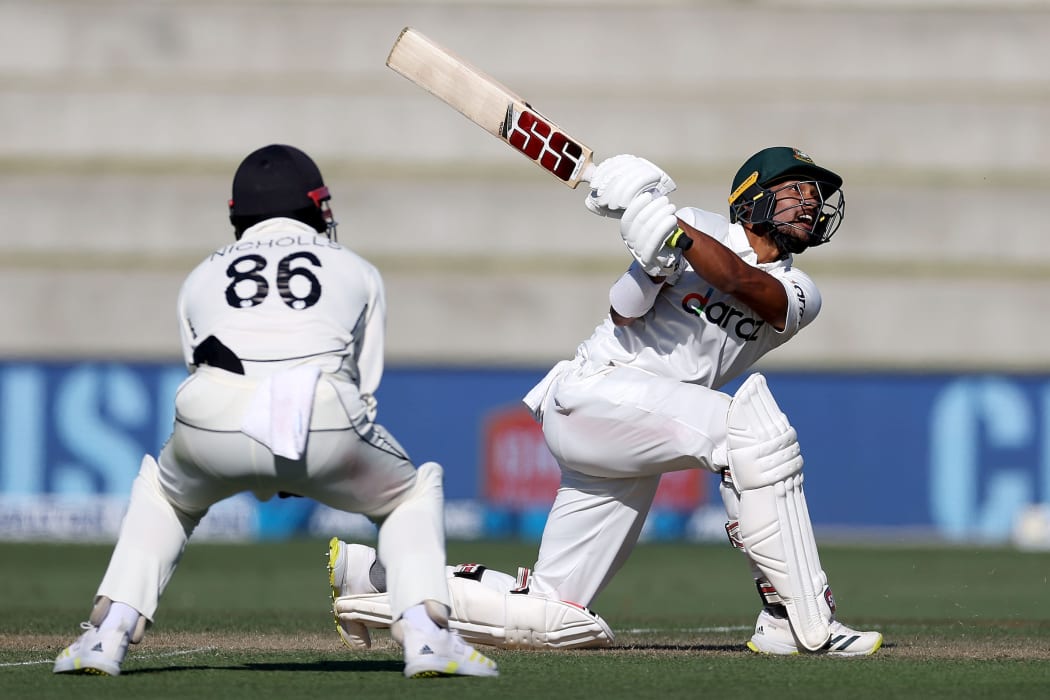 Bangladesh's Najmul Hossain Shanto (R with Blackcaps Henry Nicholls during play on day two of the first cricket test between Bangladesh and New Zealand at Bay Oval in Mount Maunganui