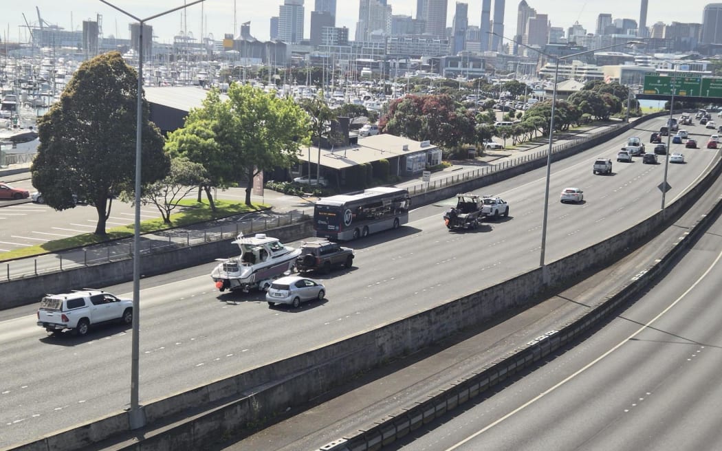 Cars towing boats travel across the city on Saturday morning.