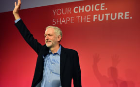 Jeremy Corbyn acknowledges the applause of the crowd as he stands on stage after being announced as the new leader of Britain's opposition Labour party.