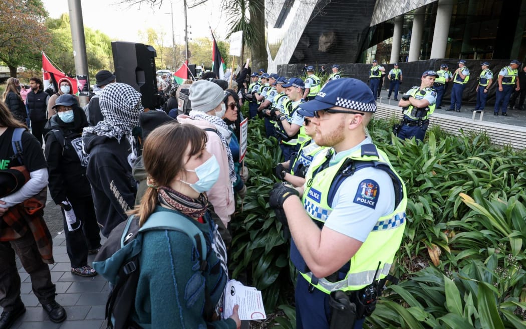 Several protesters have been carried away by police outside the national aerospace summit in Christchurch.