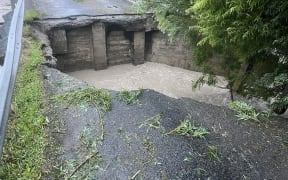 The single-lane bridge to Lake Ferry, Wairarapa, has been gouged out by floodwaters.