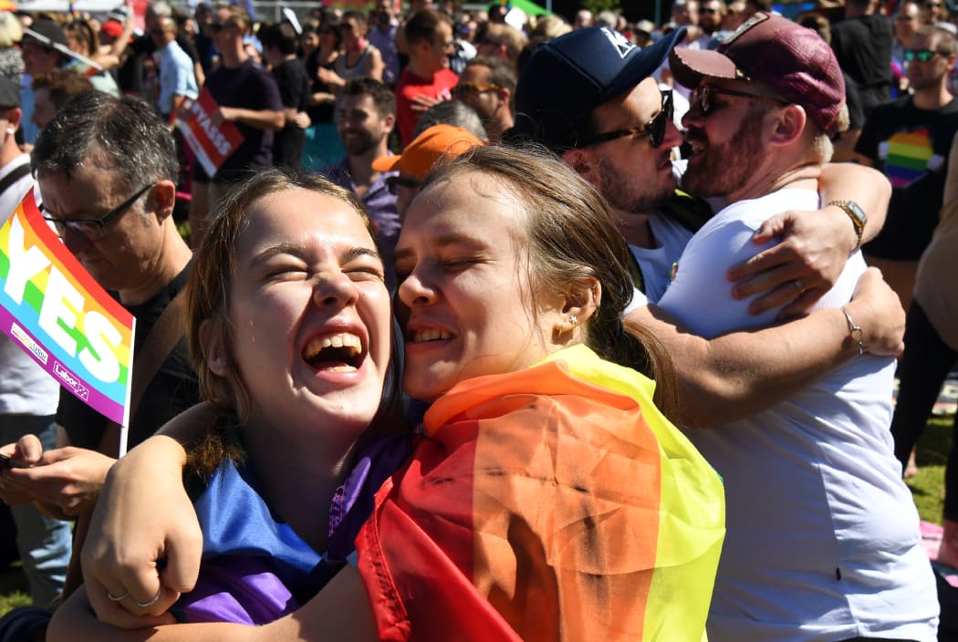 Supporters of the same-sex marriage "Yes" vote gather to celebrate the announcement in a Sydney park.