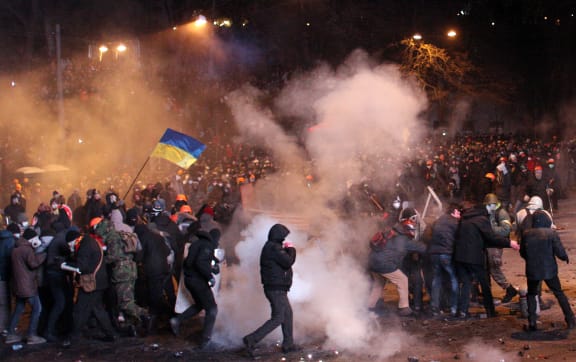 Protesters clash with riot police in the Ukrainian capital, Kiev.