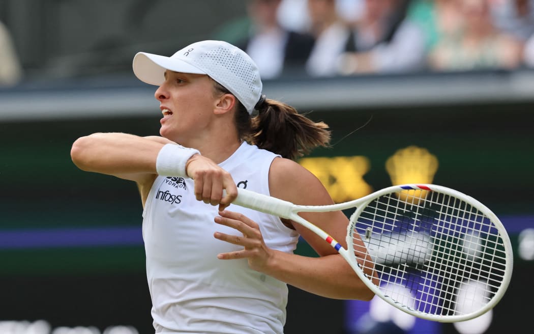 Iga Swiatek of Poland returns the ball to Caty McNally of the United States during the women's singles second-round match at Wimbledon, 3 July 2024. (Photo by Daisuke Urakami / The Yomiuri Shimbun via AFP)