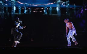 Rapper Snoop Dogg (left) and a hologram of deceased rapper Tupac Shakur perform onstage during Coachella 2012 in Indio, California.