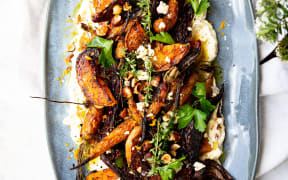 An oval platter containing Roast Butternut and Beet Salad With Orange Whipped Feta and Hazelnuts.