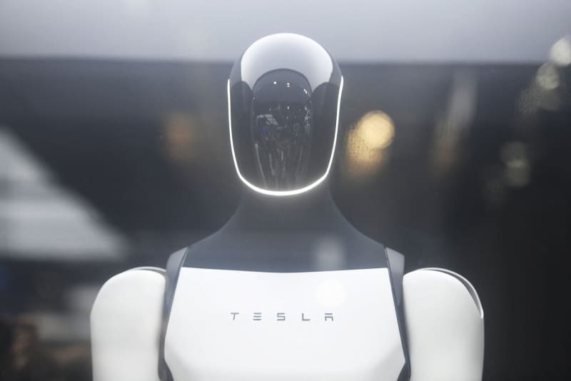 Visitors visit Tesla's humanoid robot "Optimus" at the 2025 World Artificial Intelligence Conference in Shanghai, China on July 28, 2025.