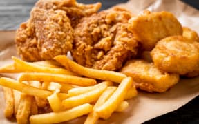 Fried chicken nuggets with chips.