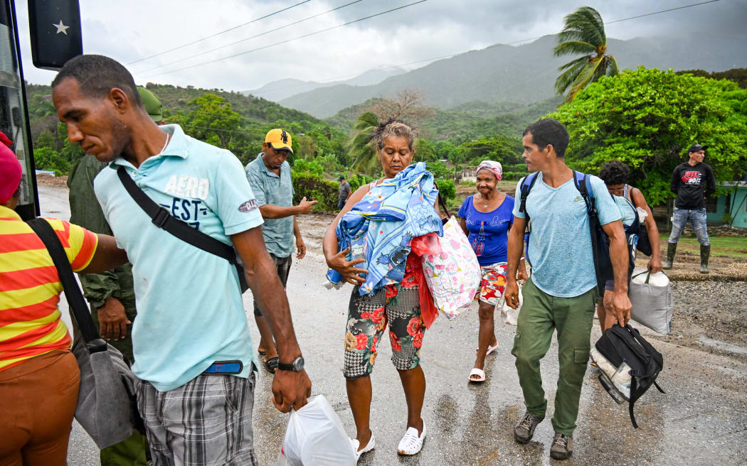 Residents are evacuated from Playa Siboney to safe locations ahead of the arrival of Hurricane Melissa, in Santiago de Cuba, Cuba, on October 28, 2025. Hurricane Melissa was set to strike nearby eastern end of Cuba late Tuesday after pummeling Jamaica. (Photo by YAMIL LAGE / AFP)