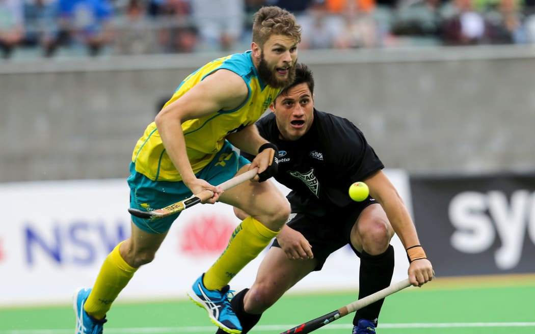 George Muir of the Black Sticks contests a loose ball again Australia during the side's 6-nil loss in the Oceania Cup final.