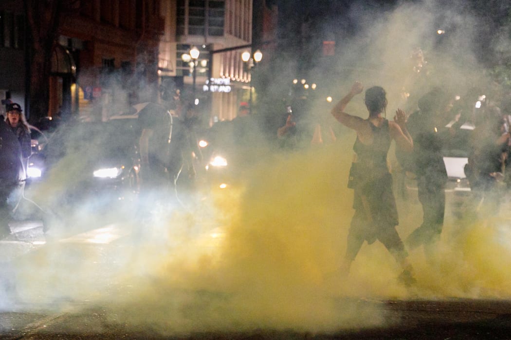 Police confront demonstrators as Black Lives Matter supporters demonstrate in Portland, Oregon on July  4,  2020 for the thirty-eighth day in a row at Portland's Justice Centre.