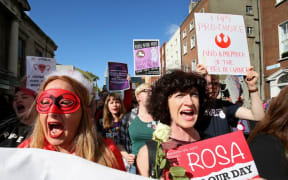 Protesters hold up placards as they take part in the March for Choice, calling for the legalising of abortion in Ireland after a referendum announcement.
