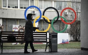 A woman smokes in front of the Russian Olympic Committee (ROC) headquarters in Moscow on November 26, 2019. - Russia's anti-doping chief said on November 26, 2019 he expected the country to be barred from all sporting competition for four years,