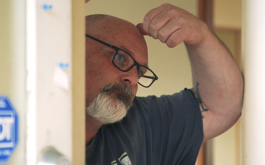 Dave Skelling in his Ranui house, which was damaged in the Auckland Anniversary weekend floods.