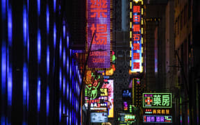 Neon signage for the Landmark Casino (C) is seen in Macau on January 22, 2020, after the former Portuguese colony reported its first case of the new SARS-like virus that originated from Wuhan in China. - Macau on January 22 reported its first confirmed case of the new SARS-like coronavirus as authorities announced all staff in the city's bustling casinos had been ordered to wear face masks. (Photo by Anthony WALLACE / AFP)