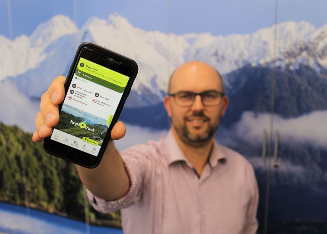 Operations manager Nathan Watson holding the app.
