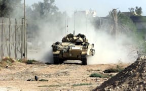 British Desert Rats drive their Warrior tank into the north of Basra, Iraq, 06 April 2003.