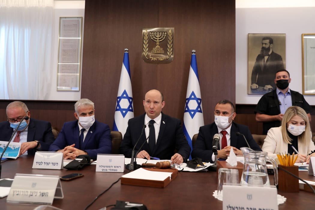 Israeli Prime Minister Naftali Bennett (C) attends a cabinet meeting at his office in Jerusalem, on October 24, 2021.