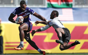 USA's Matai Leuta fends off a Fiji defender during his side's 19-7 win