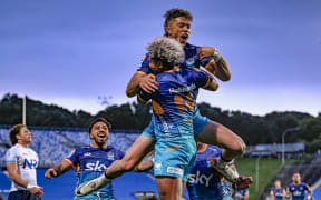 Fine Inisi of Moana Pasifika celebrates his try with team.