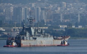 Russian Landing Ship Caesar Kunikov supported by tug boats floats at the Black sea gulf of Varna east of the Bulgarian capital Sofia, Friday, Aug. 2014. The ship was in Bulgaria for planed repair at the (Photo by Impact Press Group / NurPhoto / NurPhoto via AFP)