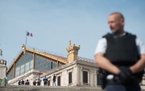 A French police officer stands outside Saint-Charles train station in Marseille on October 1, 2017, after a man armed with a knife killed two people before being shot by soldiers patrolling the area.
