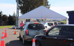 Cars line up as people wait to get vaccinated.