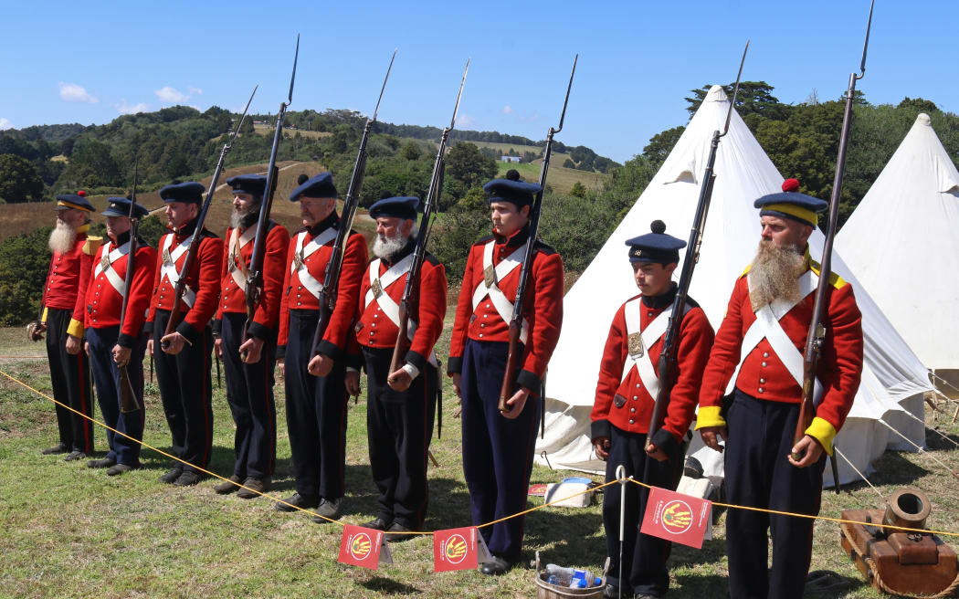 Members of the New Zealand Wars Re-enactment Society stand to attention during 175th anniversary commemorations of the Battle of Ruapekapeka Pā in 2021.