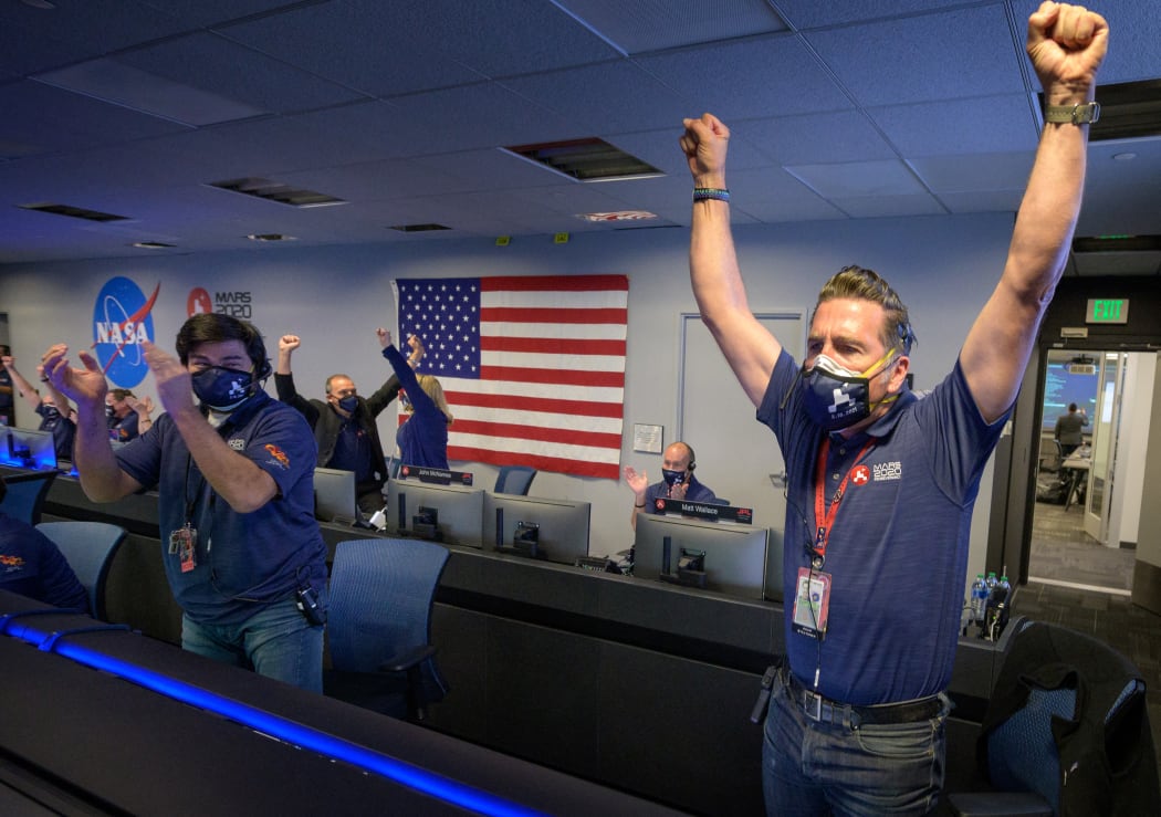 NASA's Perseverance rover team cheer and applaud afterreceiving confirmation the spacecraft successfully touched down on Mars on 18 February 2021.