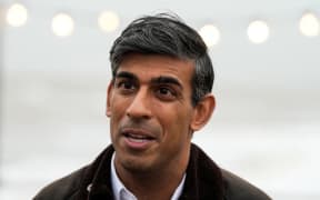 Britain's Prime Minister Rishi Sunak speaks to a TV reporter  during a visit to Clacton-on-Sea, south east England, on October 18, 2023. (Photo by Frank Augstein / POOL / AFP)
