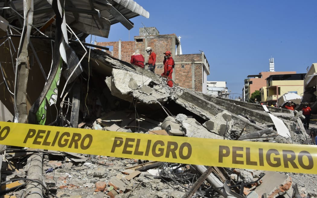 Peruvian rescuers work at the Tarqui neigborhood in Manta, Ecuador.
